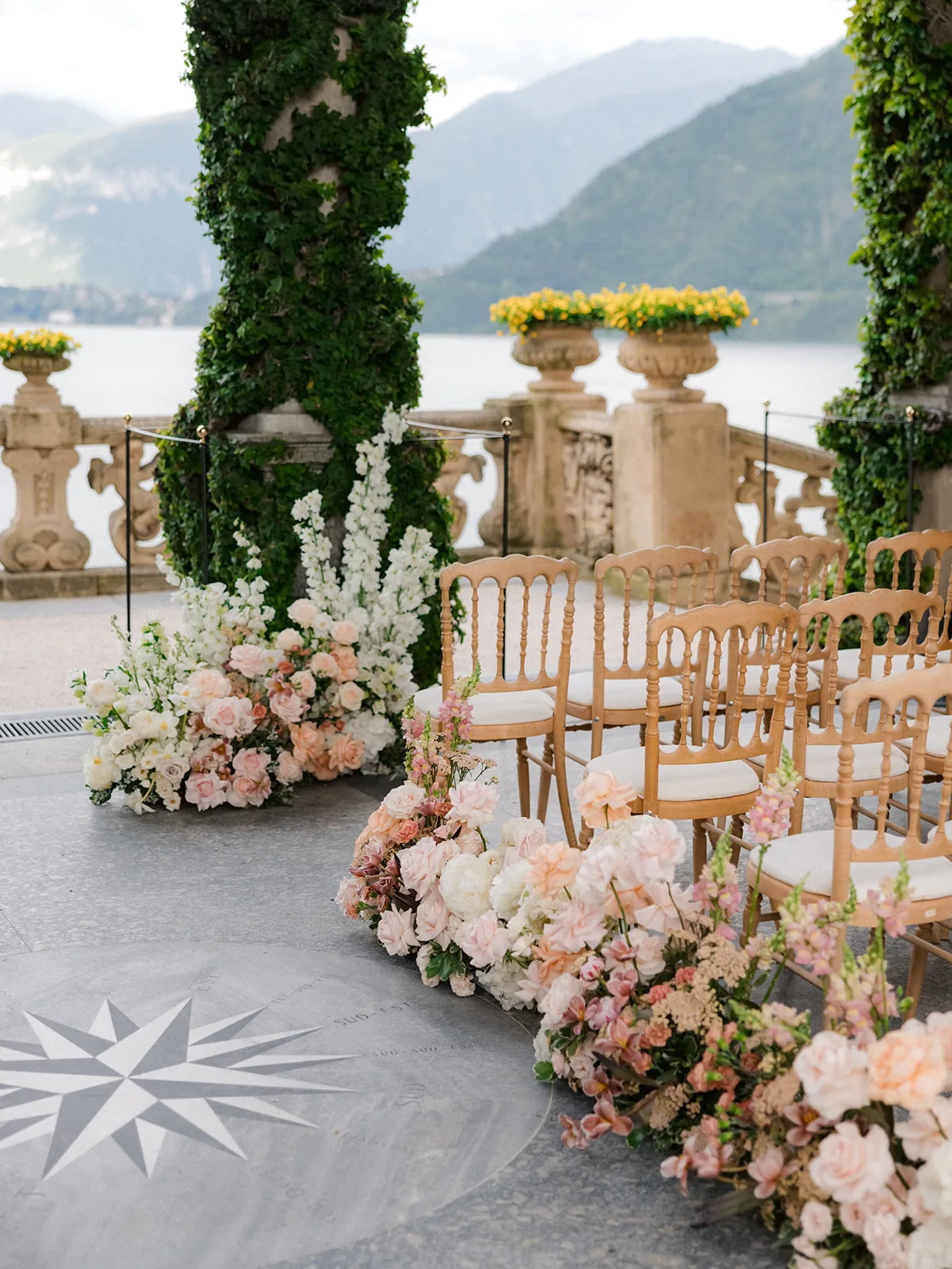 Lakeside ceremony setting with flowers and guest chairs